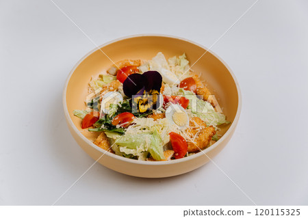 Fresh Caesar salad with crispy chicken, boiled egg, cherry tomatoes, parmesan, and edible flower Fresh Caesar salad with crispy chicken, boiled egg, cherry tomatoes, parmesan, and edible flower 120115325