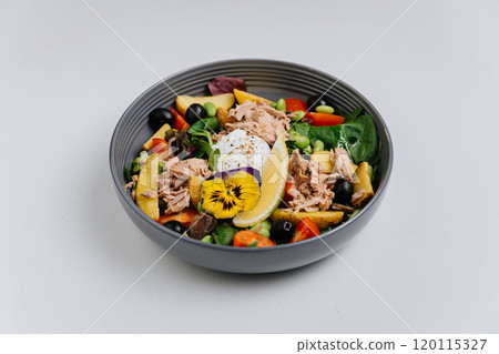 Vibrant salad bowl with tuna, poached egg, olives, and edible flower, fresh and healthy meal choice Vibrant salad bowl with tuna, poached egg, olives, and edible flower, fresh and healthy meal choice 120115327