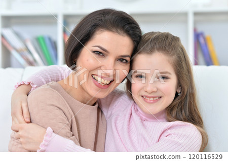 Little girl with her mother posing at home 120116529