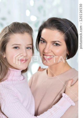 Little girl with her mother posing at home 120116530