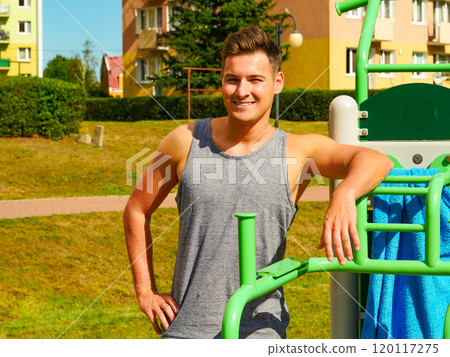 Young man relaxing after outdoor workout 120117275
