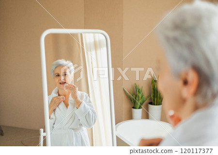 Love yourself. Beautiful old woman enjoying mirror reflection. Senior older lady spending morning in bathroom looking at mirror confident happy. Woman doing daily morning beauty routine. Self love Love yourself. Beautiful old woman enjoying mirror reflection. Senior older lady spending morning in bathroom looking at mirror confident happy. Woman doing daily morning beauty routine. Self love 120117377