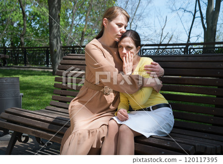 Two girls comfort one another Two girls comfort one another 120117395