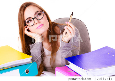 Woman sitting at desk in office and thinking 120117415