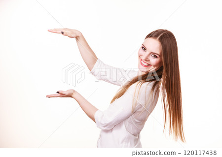 Woman uses hands to indicate area of frame, copy space for product 120117438
