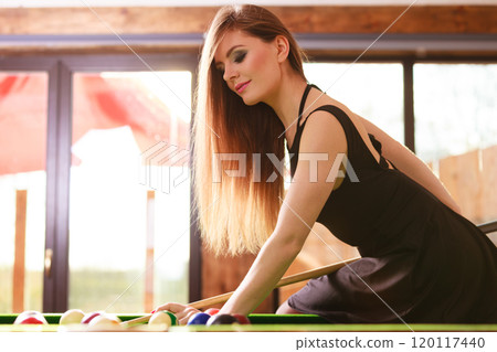 Young woman playing billiard. Young woman playing billiard. 120117440