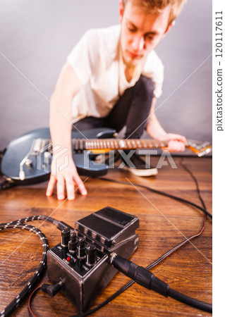 Man setting up guitar equipment Man setting up guitar equipment 120117611