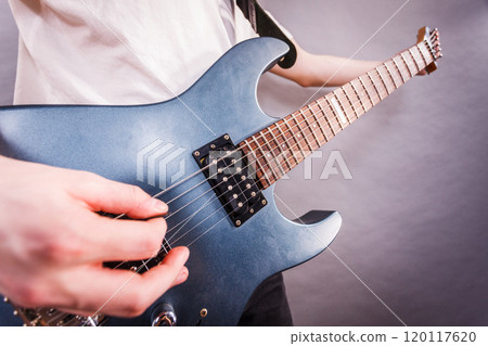 Close up of man playing on electric guitar Close up of man playing on electric guitar 120117620