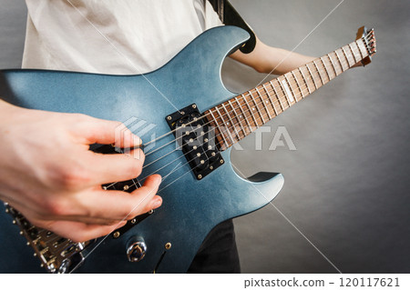 Close up of man playing on electric guitar 120117621