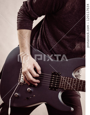 Male hands playing electric guitar 120117634