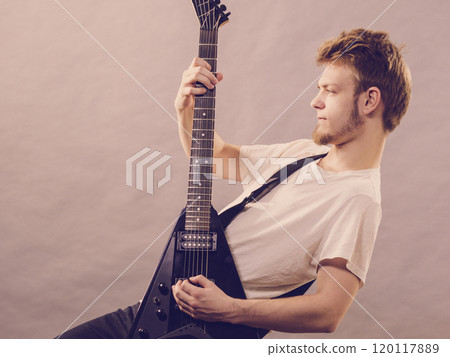 Man playing on electric guitar Man playing on electric guitar 120117889