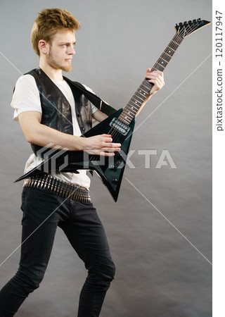 Young man playing electric guitar Young man playing electric guitar 120117947