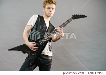 Young man playing electric guitar Young man playing electric guitar 120117958