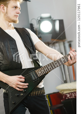 Man playing on electric guitar 120117961
