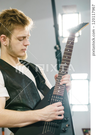 Man playing on electric guitar 120117967