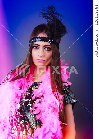 Girl pink plume and black feather on head. Carnival. 120118262