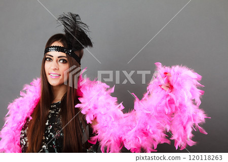 Girl pink plume and black feather on head. Carnival. 120118263