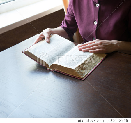 Woman's hands holding a bible 120118346
