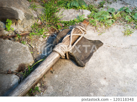 Stone ax of a primitive man 120118348