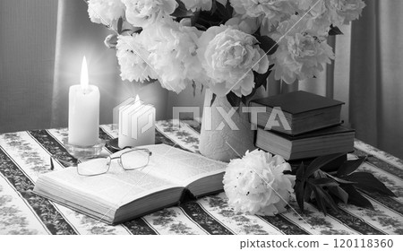 Book near a bouquet of flowers 120118360
