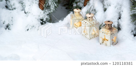 Lanterns in the snow under the Christmas tree 120118381