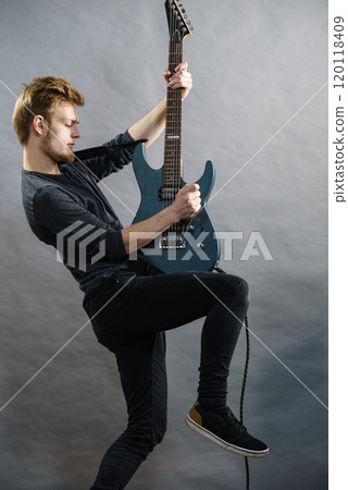 Man playing on electric guitar 120118409