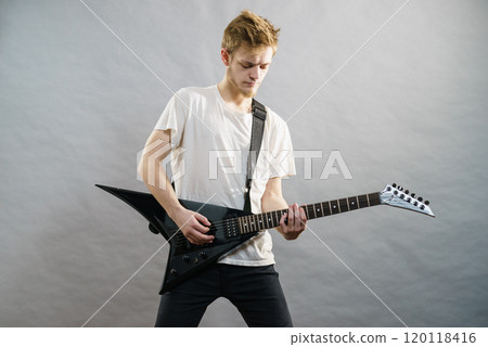 Man playing on electric guitar Man playing on electric guitar 120118416