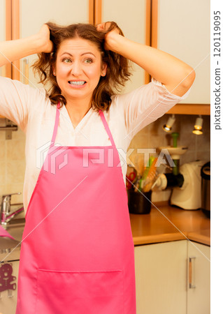 Unhappy housewife in kitchen Unhappy housewife in kitchen 120119095
