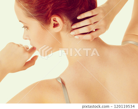 Redhead naked woman touching her hair and mouth 120119534