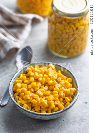 Canned sweet corn in bowl on kitchen table. 120121012