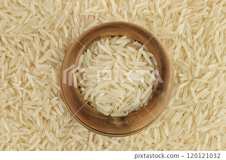 rice basmati in wooden bowl as a background. Top view. Flat lay 120121032
