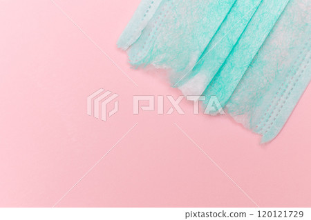 Green Torn Medical Face Mask on the Pink Background Green Torn Medical Face Mask on the Pink Background 120121729