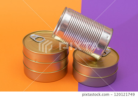 A Group of Stacked Tin Cans with Blank Edges on Split Orange and Violet Background A Group of Stacked Tin Cans with Blank Edges on Split Orange and Violet Background 120121749