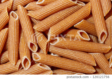 Uncooked Whole Grain Penne Rigate Pasta Background 120121756