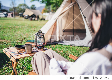 Young woman resting in a chair at camp 120121937
