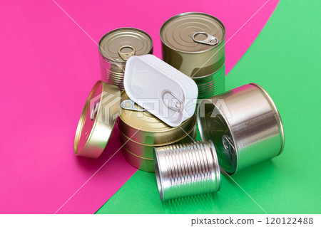 A Group of Stacked Tin Cans on Split Green and Cyan Background A Group of Stacked Tin Cans on Split Green and Cyan Background 120122488