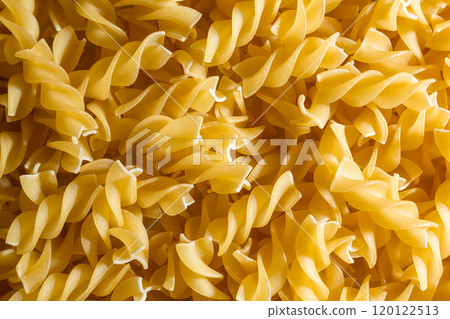Uncooked Fusilli Pasta Background Uncooked Fusilli Pasta Background 120122513
