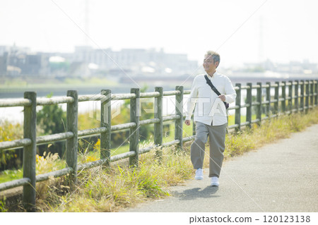 Seniors walking energetically along the bank 120123138