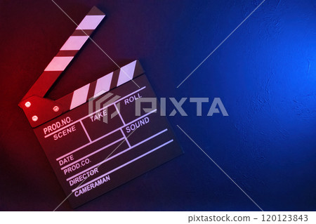 Clapperboard on black background with red and blue light, top view 120123843