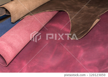 Pieces of natural calf leather with real texture. Leather craftsman's workshop. Pieces of natural calf leather with real texture. Leather craftsman's workshop. 120123850