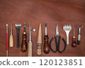 Pieces of natural calf leather and tools for leather processing. A leather craftsman's workshop. 120123851
