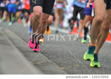 Marathon: The feet of a marathon runner running up a hill 120123956