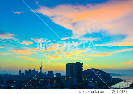 Colorful sunset over Momochihama, Jigyohama, and Fukuoka Tower in Sawara Ward, seen from the direction of Tojinmachi and Ohori Park. Pastel light blue. 120124251
