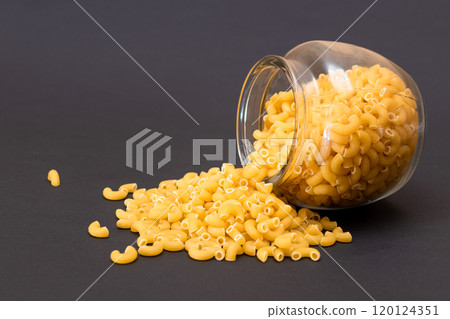 Uncooked Chifferi Rigati Pasta in Glass Jar on Black Background Uncooked Chifferi Rigati Pasta in Glass Jar on Black Background 120124351