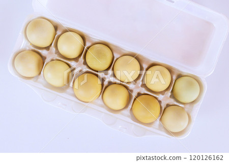An egg carton containing twelve yellow eggs ready for cooking, baking An egg carton containing twelve yellow eggs ready for cooking, baking 120126162
