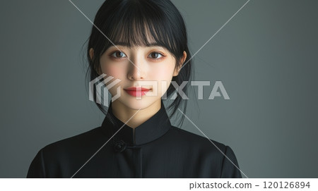Portrait of a young woman with dark hair, neutral background. Portrait of a young woman with dark hair, neutral background. 120126894
