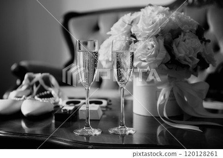 A black and white photo of a table with champagne and flowers A black and white photo of a table with champagne and flowers 120128261