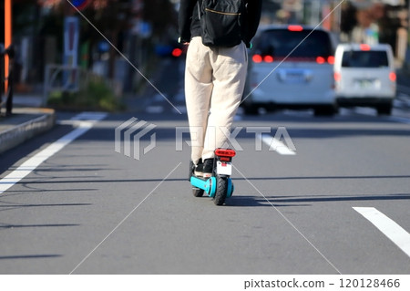 An electric kick scooter running on the road An electric kick scooter running on the road 120128466
