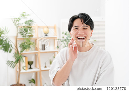 Man touching his cheek, smiling 120128778