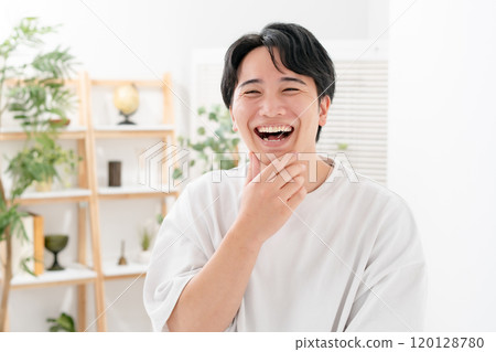 Man touching his cheek, smiling 120128780